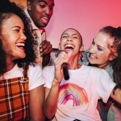 RedMR Karaoke Hong Kong, best karaoke songs, Joyful friends singing their favourite song during karaoke night. Happy young friends laughing joyfully at a house party. Group of multicultural friends having a good time on the weekend.